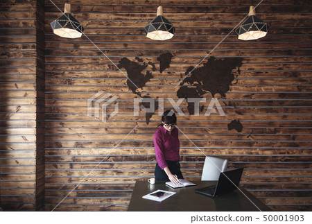 Female business executive standing at her desk Female business executive standing at her desk 50001903