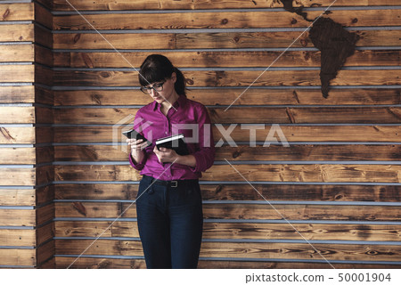 Businesswoman checking her mobile phone Businesswoman checking her mobile phone 50001904