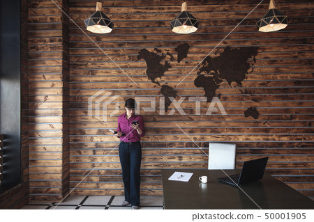 Businesswoman standing chatting on her mobile Businesswoman standing chatting on her mobile 50001905