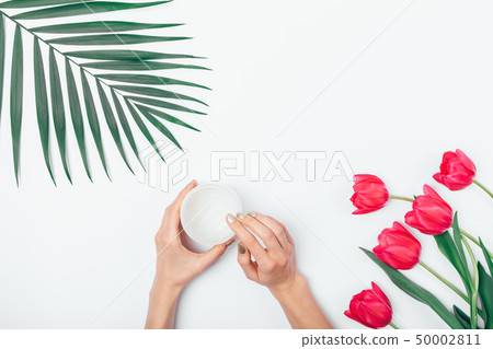 Female's hands taking cosmetic cream Female's hands taking cosmetic cream 50002811