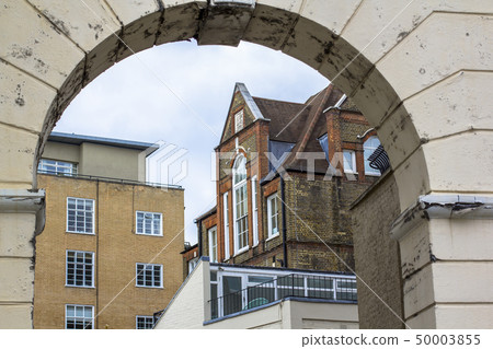 Brick multi-level house with large beautiful windows. Picture taken through the old arch. Central Brick multi-level house with large beautiful windows. Picture taken through the old arch. Central 50003855