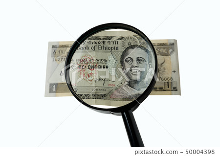 one Ethiopian birr bill and magnifying glass one Ethiopian birr bill and magnifying glass 50004398