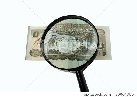 one Ethiopian birr bill and magnifying glass 50004399
