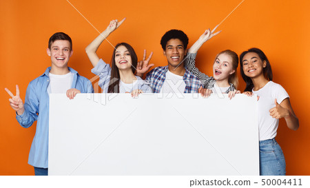 Happy friends holding empty banner, orange background Happy friends holding empty banner, orange background 50004411