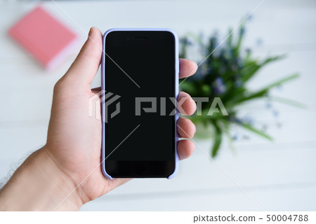 Male hand with a smartphone. Black blank screen. Male hand with a smartphone. Black blank screen. 50004788
