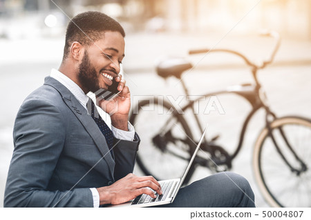 Always in touch. Happy manager working on laptop Always in touch. Happy manager working on laptop 50004807