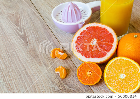 various citrus fruits, reamer and juice various citrus fruits, reamer and juice 50006814