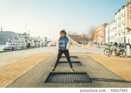 adult person rejoices like child. Playground trampoline in ground, children trampoline, springs 50007965