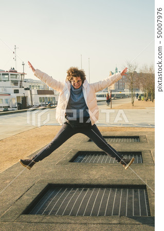 adult person rejoices like child. Playground trampoline in ground, children trampoline, springs 50007976