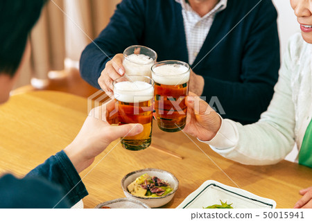 Family group dinner evening toast 50015941