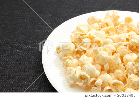 Popcorn served in a paper plate. Popcorn served in a paper plate. 50018493