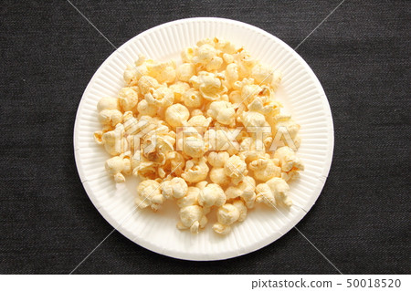 Popcorn served in a paper plate. Popcorn served in a paper plate. 50018520