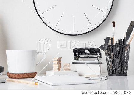 Office supplies and wall clock on white Office supplies and wall clock on white 50021080