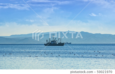 fishing boat in gray morning on Pacific ocean off fishing boat in gray morning on Pacific ocean off 50021970