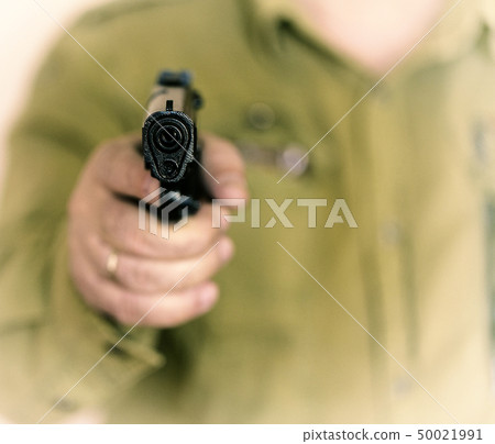 Man pointing gun at the target with one Hand 50021991