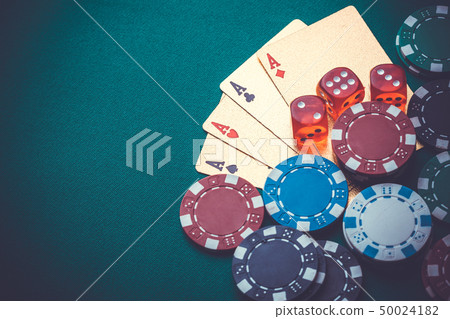 playing cards, chips, dice, on a green table. 50024182