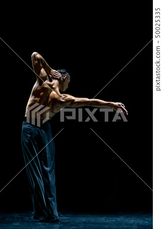 female muscular ballroom dancer making pose isolated on black 50025335