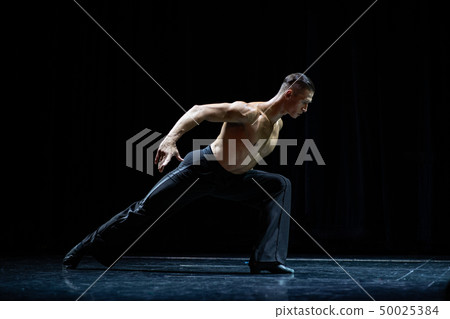 female muscular ballroom dancer making pose isolated on black 50025384