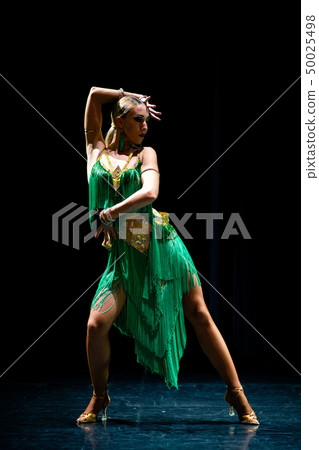 young beautiful female dancer posing on black background 50025498