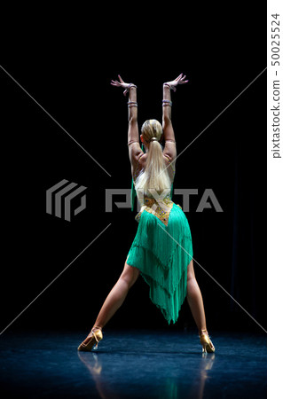 young beautiful female dancer posing on black background young beautiful female dancer posing on black background 50025524
