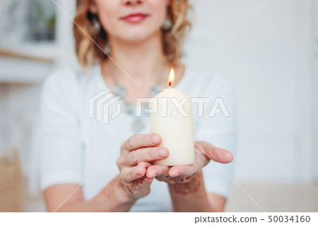 Blonde young woman in white clothing with mehendi 50034160