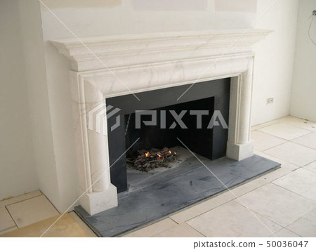 Stylish fireplace with fire in home interior Stylish fireplace with fire in home interior 50036047