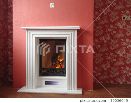 Stylish fireplace with fire in home interior Stylish fireplace with fire in home interior 50036049
