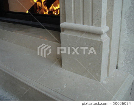 Stylish fireplace with fire in home interior Stylish fireplace with fire in home interior 50036054