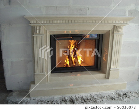Stylish fireplace with fire in home interior 50036078