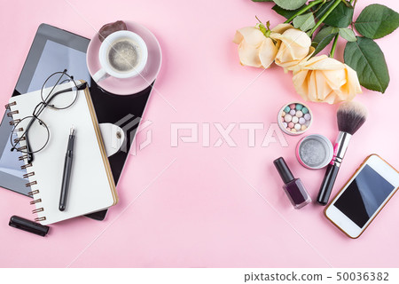 Stylized feminine flatlay with Coffee mug, roses flower, glasses and tablet mock up isolated on pink 50036382