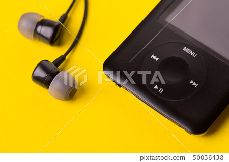 Black headphones and player close-up. 50036438