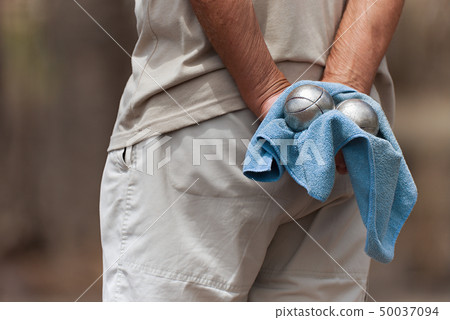 Hand of holding petanque ball Hand of holding petanque ball 50037094