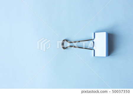 Blue clip on blue background Blue clip on blue background 50037350