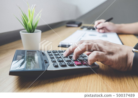 Businessman working on a graph document financial Businessman working on a graph document financial 50037489