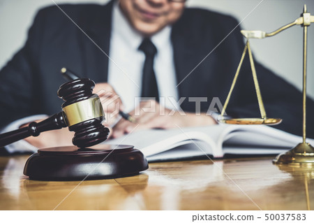 Male lawyer or judge working with contract papers, Male lawyer or judge working with contract papers, 50037583