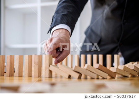 Wooden game strategy, Businessman hand stopping 50037617
