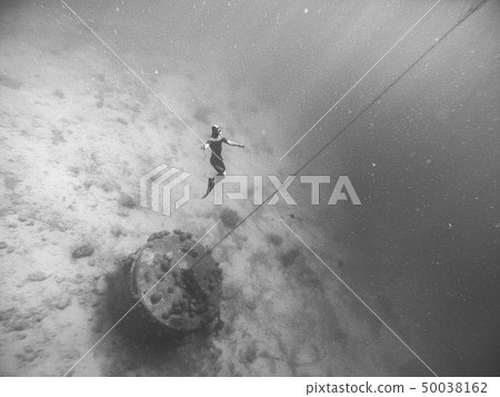 The freediver is at a very great depth close to bottom of the sea The freediver is at a very great depth close to bottom of the sea 50038162