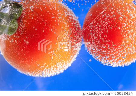 ripe tomato in water close-up 50038434