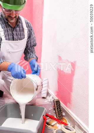 House painter worker at work in the construction House painter worker at work in the construction 50039229