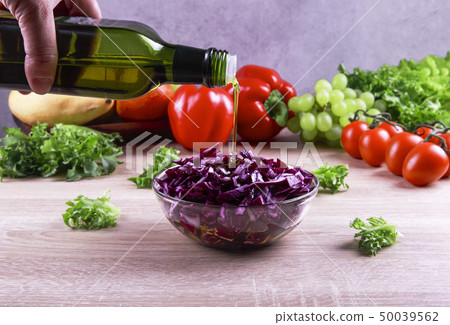 fresh red cabbage salad with vegetables in the background 50039562