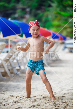 Portrait of a beautiful baby boy on the beach  Portrait of a beautiful baby boy on the beach  50040277