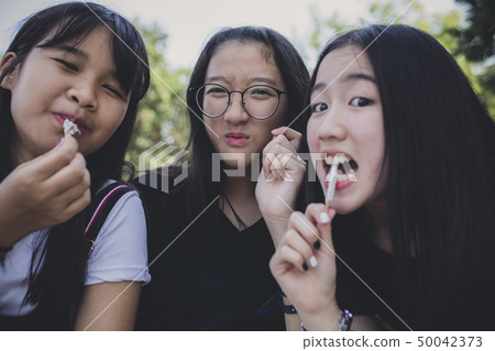 group of asian teenager relaxing and eating snack group of asian teenager relaxing and eating snack 50042373