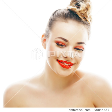 young blond woman with bright make up smiling pointing gesturing emotional isolated like doll lashes 50044847