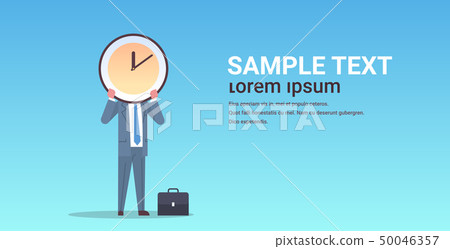 businessman holding clock in front of face effective time management deadline business efficiency businessman holding clock in front of face effective time management deadline business efficiency 50046357