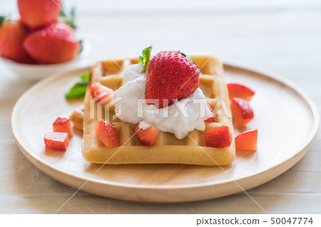 waffle with strawberry on wood 50047774