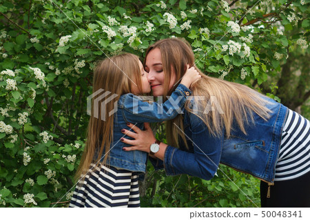 Family. Mother and daughter. Hugs and kisses 50048341