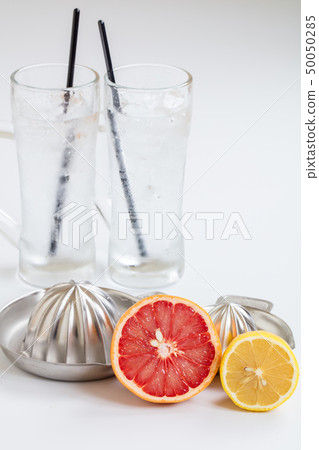 Raw simmered sour comparing lemon and grapefruit on sour on white background Raw simmered sour comparing lemon and grapefruit on sour on white background 50050285
