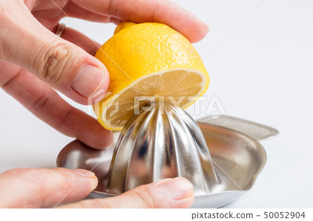 Liquor juice squeezed to squeeze lemon on white background 50052904