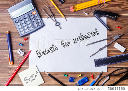 Album sheet with text - back to school and student material on wooden table. Album sheet with text - back to school and student material on wooden table. 50053160