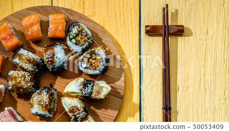 Japanese rolls on wooden board Japanese rolls on wooden board 50053409
